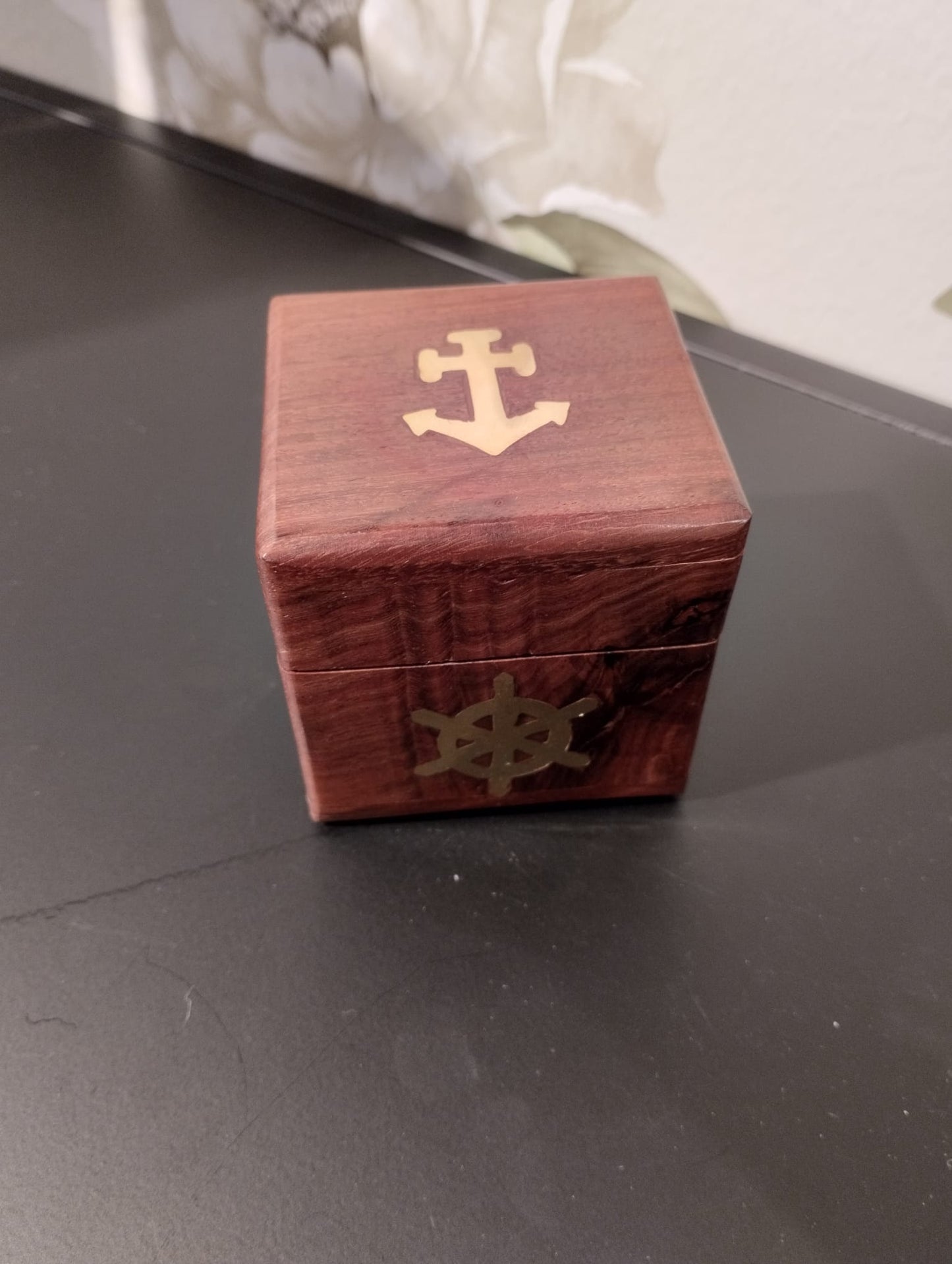 Fin, dekoartivt träask med nautisk motiv som innehåller 6 mindre tärningar för att spela t.ex. maxi yatzee. Material: trä, mässing Mått Träask: 7x7x7 cm Mått Tärningar: 2x2x2 cm