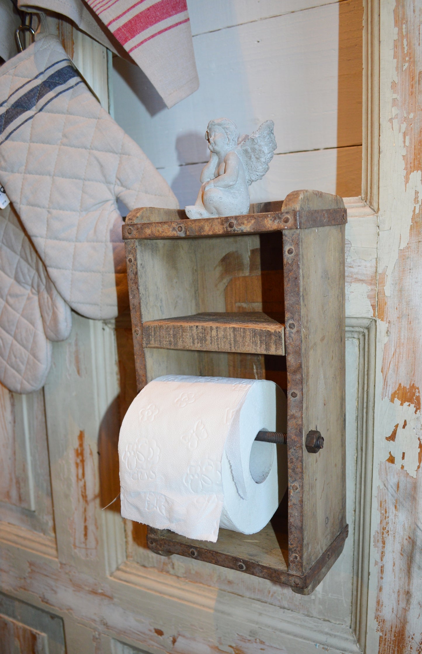 Rustik toalettpappershållare som är tillverkad av en gammal murstensform. Det finns en liten hylla. Passar bra för en vanlig toalettpappersrulle.  Mått: H 30cm, L 15cm, B 10cm  Material: Trä. OBS: Detta är en unik produkt, storlek och utseende kan variera lite. Metallbeslag kan fattas vilket gör att de ser naturligt slitna ut. Det kan även förekomma sprickor i träskivorna.